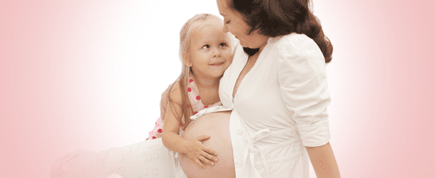 Pregnant Woman Holding a Little Girl